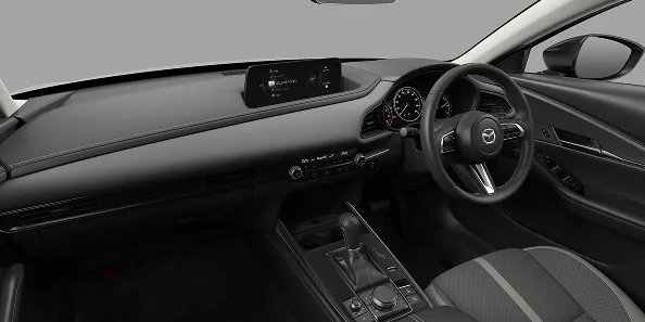 CX-30の運転席まわりを助手席側から見た様子。ダッシュボードの上に横長の画面があり、手前に灰色の線の入った布のシートが見える